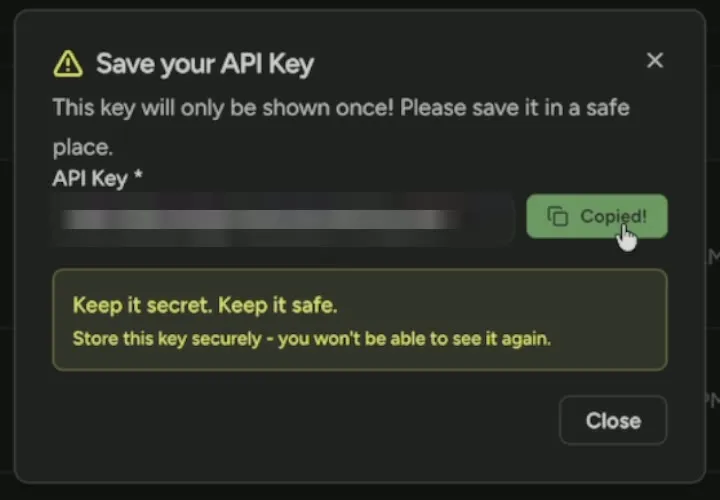 The Save your API Key dialog, key hidden, with the Copy Key button showing Copied